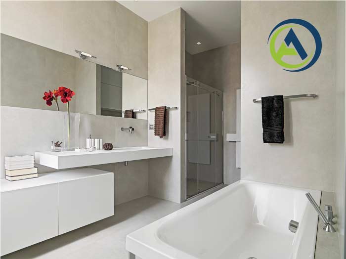 Sleek, minimalist new bathroom with a floating white vanity, long horizontal mirror, white bathtub, and glass shower, highlighting high-quality finishes from A-1 Contractors.