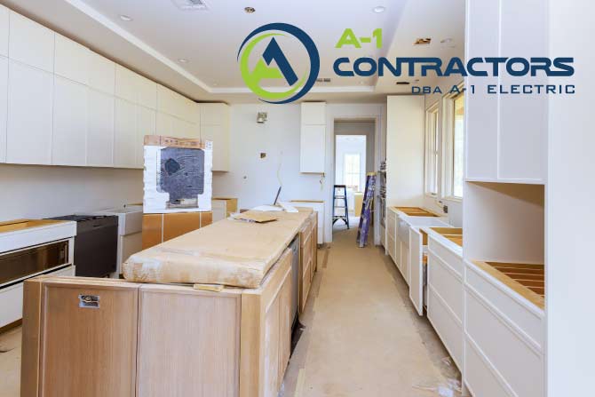Newly installed white kitchen cabinets and central island during construction by A-1 Contractors, demonstrating a major remodel project.