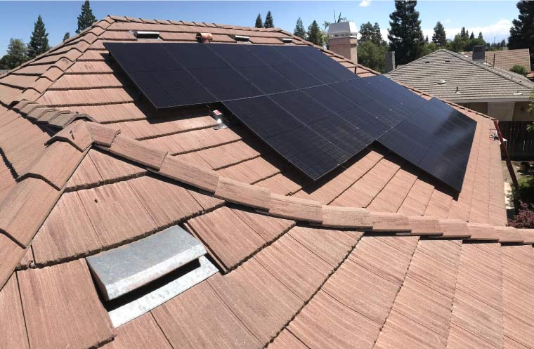 Rooftop solar energy system installed on a home with brown concrete tiles, showcasing clean installation for maximum property value